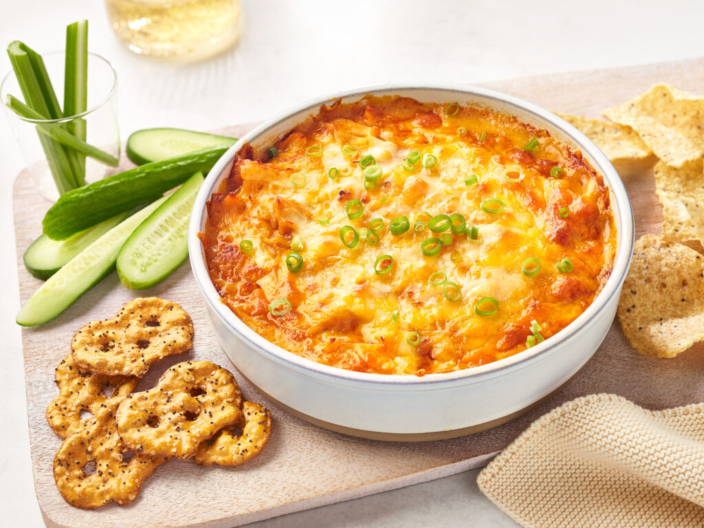 An image of prepared Easy Buffalo Chicken Dip made with 2 cups shredded Monterey Jack cheese, Campbell's® Condensed Spicy Buffalo-Style Cream of Chicken Soup, Swanson® Premium White Chicken Breast